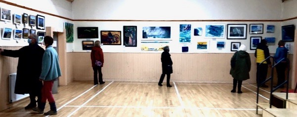 Viewers enjoying the 70 pictures in the Exhibition.